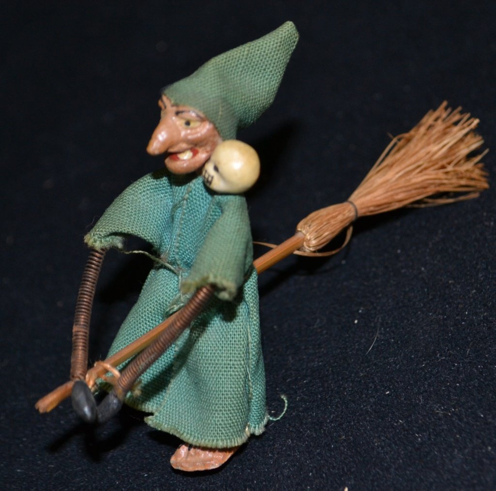 Early Halloween Witch Ornament: Early Halloween ornament of a witch on a broom with a skull companion on her shoulder, with spring arms and legs, composite face, 3.25"H