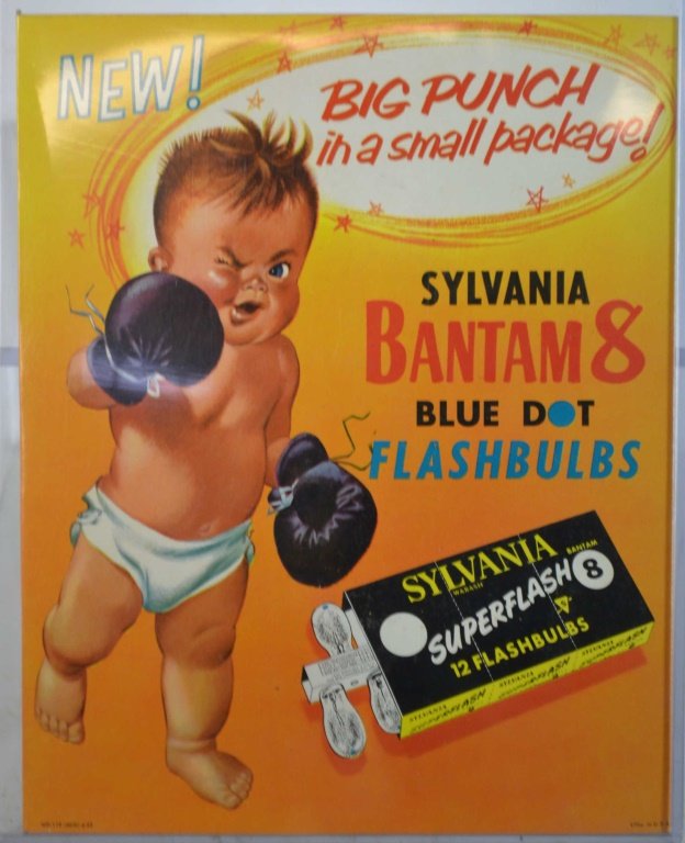 Phantom 8 Sylvania flash bulb advertising: Phantom 8 Sylvania flash bulb advertising. NOS standing cardboard advertising depicting a baby w boxing gloves. Approx 10 x 13 inches.