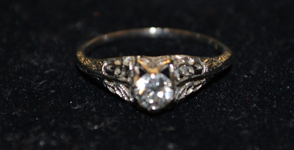 10K White Gold Diamond Ring: 10 K white gold filigree setting containing an old mine cut diamond, approx. 0.25ct, 1.1 DWT