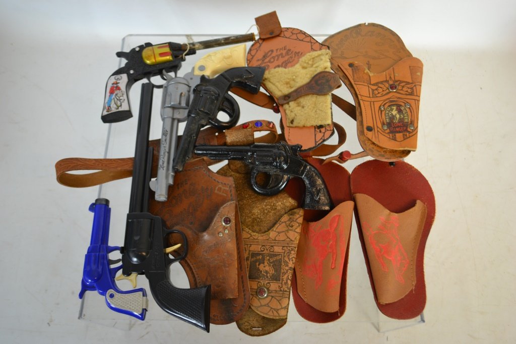 Large Collection Of Lone Ranger Holsters: Large Collection Of Lone Ranger Holsters including: cast guns, smoker gun,( w/ instructions and advertising) cork gun, noise maker gun, and another gun