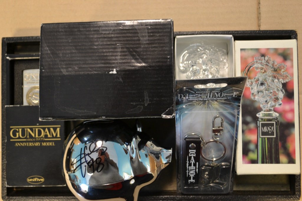 Misc. Lot Of Collectors Items: Misc. Lot Of Collectors Items including: Unknown Signature on Piggy Bank, Gundam Zippo Lighter, Deathnote Keychain, and Mikasa Wine Bottle Topper