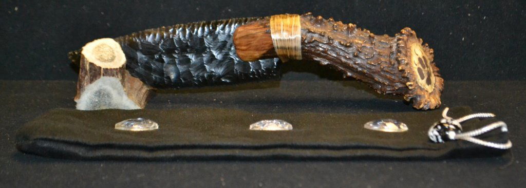 Handmade Obsidian Knapped Tony Stanfield Knife: Handmade Obsidian Knapped Tony Stanfield Knife with 6 inch knapped obsidian blade tied with artificial sinew to antler handle; pommel stamped with bear paw icon; 11 inches overall; comes with velour p
