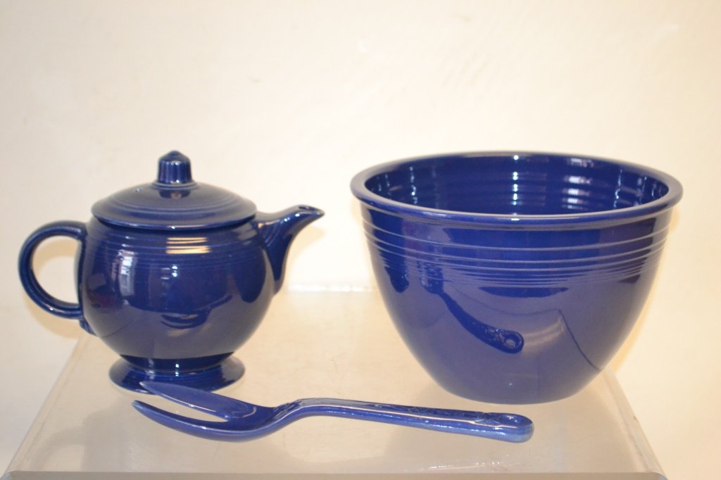Early Blue Fiestaware Mixing Bowl and Teapot: Early Blue Fiestaware Mixing Bowl and Teapot; mixing bowl measures approx 5.5" H x 9" diameter, teapot measures 6.5" H; also includes matching blue serving spork
