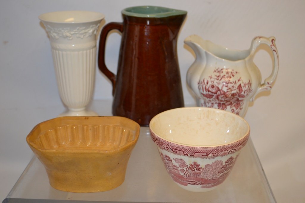 Grouping of English Pottery: Grouping of English Pottery including a red transfer iron stone pitcher, red transfer willow pattern, yelloware mold, majolica pitcher, and a 10" Wedgewood vase.