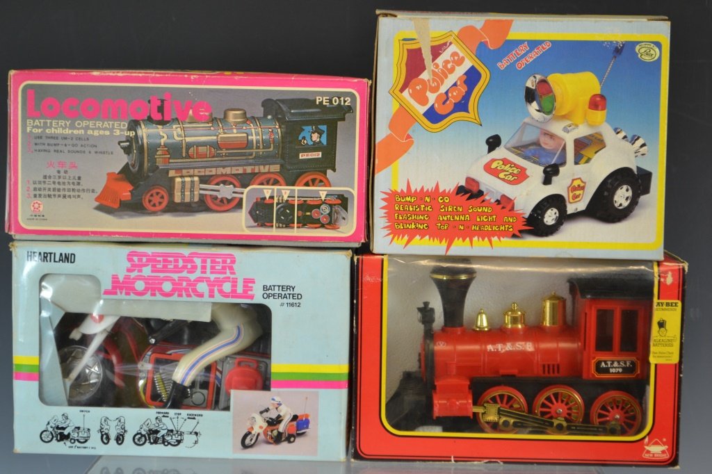 Four Vintage Battery Operated Toys: Battery operated Speedster Motorcycle by Heartland in original box (box opened and age discolored), battery operated tin and plastic Locomotive PE 012 by ASH in original box (age worn), New Bright bat