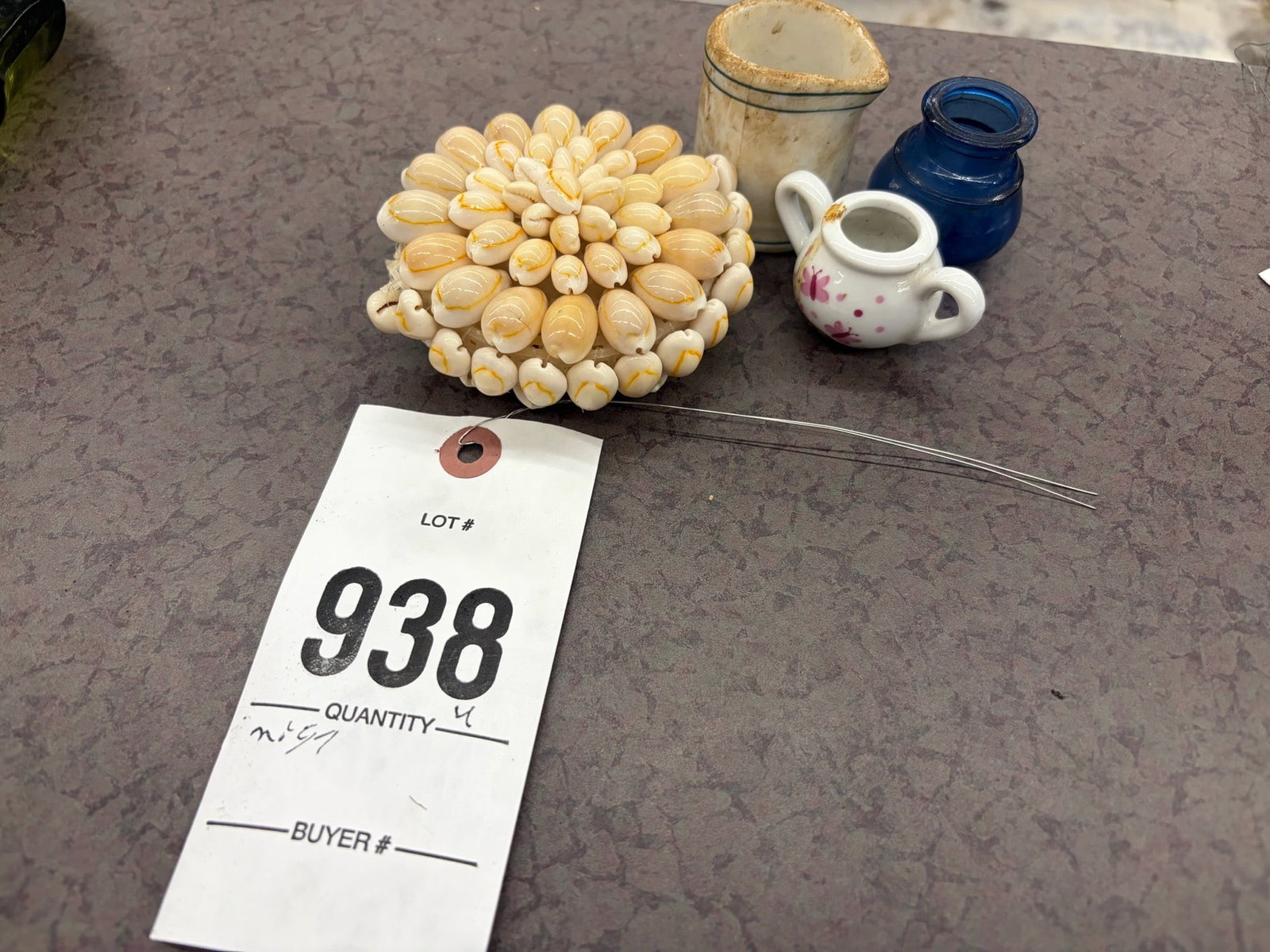 Decorative Items Including Mini Pitchers: Lot consisting of a shell-crafted floral design, a ceramic mini pitcher with discoloration and wear, a small porcelain teapot with floral decoration, and a cobalt blue glass item.