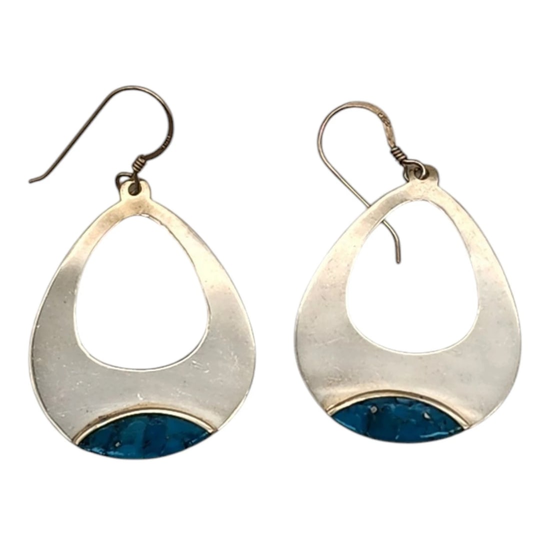 Vintage Southwest Sterling Silver .925 Turquoise Earrings: A beautiful pair of vintage Mexican or Southwestern style open teardrop dangle earrings. Crafted with a polished silver-tone finish, each earring features a bold, fluid cutout center that brings a mod
