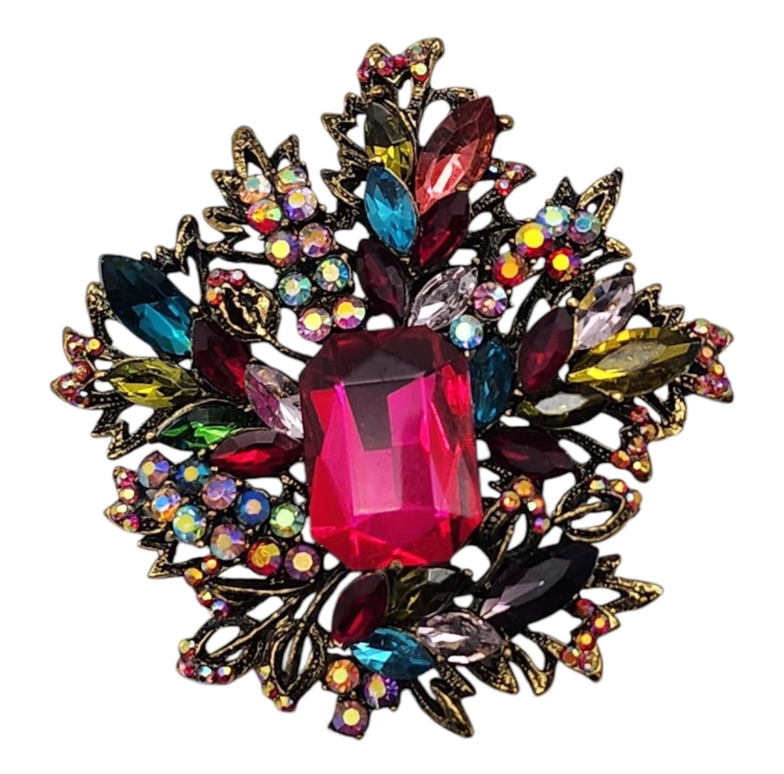 Gold Tone Multicolor AB Vivid Pink Center Rhinestone Statement Brooch Pendant 3": A showstopping vintage statement brooch brimming with elaborate Victorian and Hollywood Regency flair. The centerpiece features a massive, brilliant emerald-cut fuchsia pink rhinestone, surrounded by 