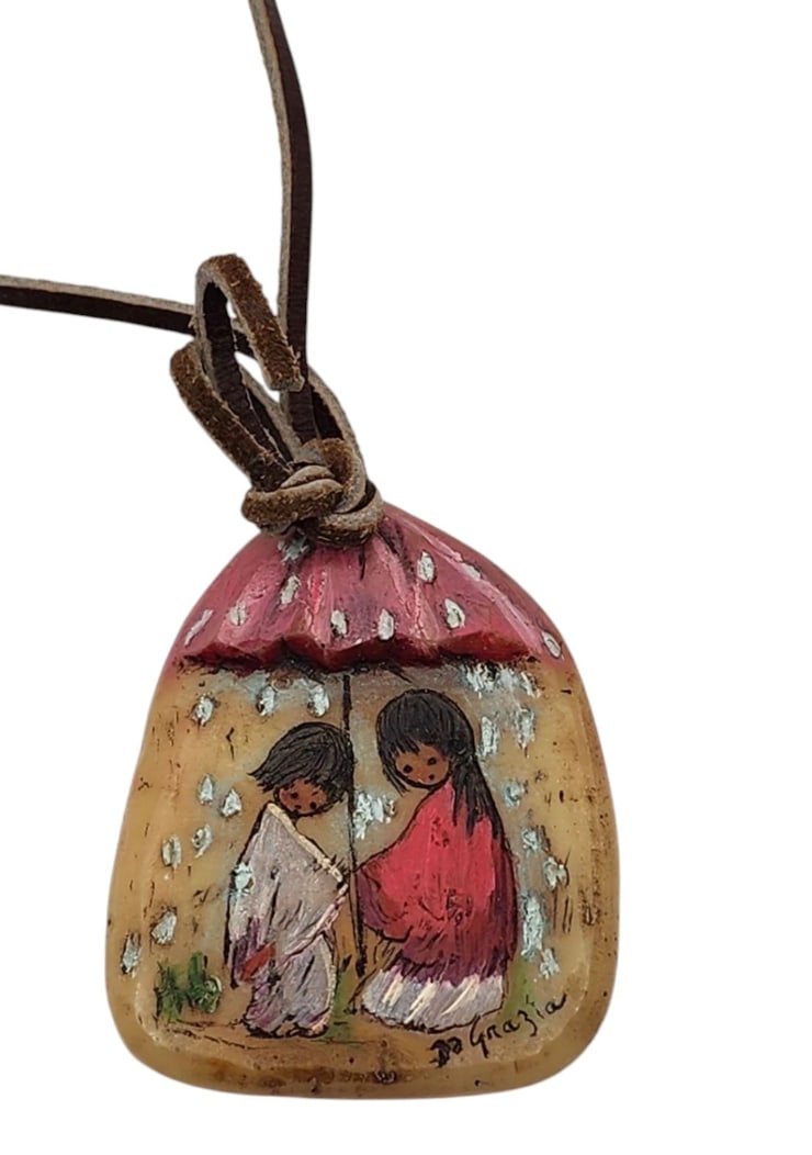 Vintage Ted DeGrazia Hand-Painted Gourd Pendant – Signed Southwestern Native Children in Rain: Features the iconic artwork of Ted DeGrazia, hand-painted details on a natural organic gourd backing, a signed artist signature on the front, and a rustic genuine leather cord.A beautiful piece of wea