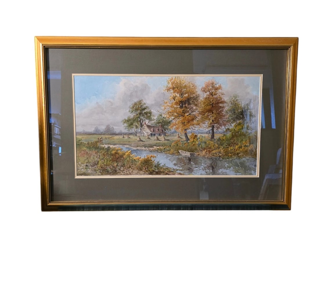 Framed Vintage Autumn Landscape Watercolor Art Print: Classic rural pastoral landscape featuring a country cottage or farmhouse nestled by a winding river.Frame/Matting: Elegantly housed in a smooth, polished gold-tone wooden frame with a wide, dark char