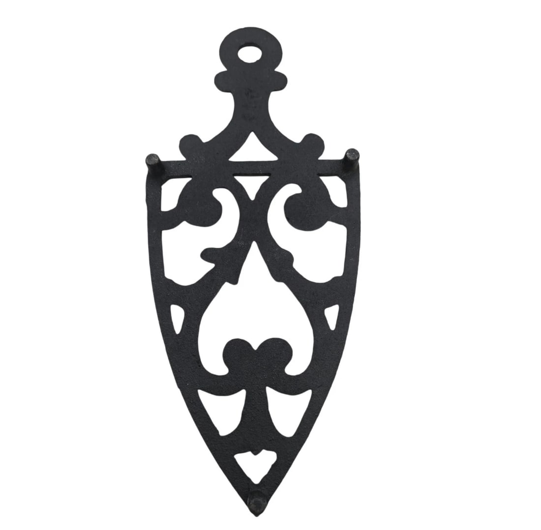 Cast Iron Trivet Black Vintage Victorian Style Shield with Heart & Scrolls: lassic shield-shaped cast iron sad iron trivet featuring a striking Gothic-inspired open scrollwork pattern that forms a central heart-like motif. It includes a top hanging loop for wall display and t