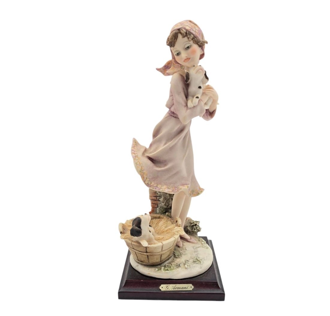 Vintage Florence Giuseppe Armani Girl With Puppies Figurine: An authentic, highly collectible Italian porcelain sculpture from Giuseppe Armani's Florence studio. It depicts a young girl in a soft lavender dress and patterned headscarf gently cradling a small sp