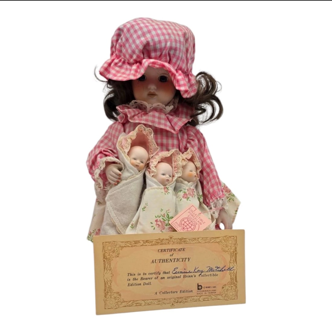 Brinn's Porcelain Doll Forla With Triplets Collectable Porcelain Edition: 1988 Collectible Edition porcelain doll from Brinn's, depicting a sweet mother doll holding three swaddled infant babies.Attire: The mother features brunette curls and is dressed in a matching pink-an