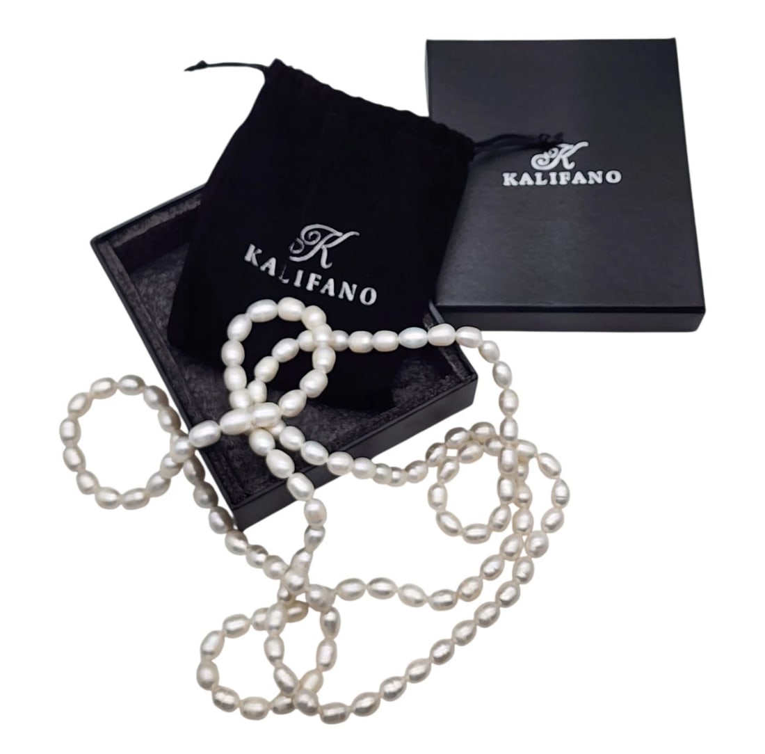Alexander Kalifano Genuine Pearl Long Necklace Unworn In Box: A luxurious, long strand necklace composed of genuine white freshwater cultured pearls with organic baroque shapes and excellent luster. Comes complete with its original Kalifano branded black velvet 