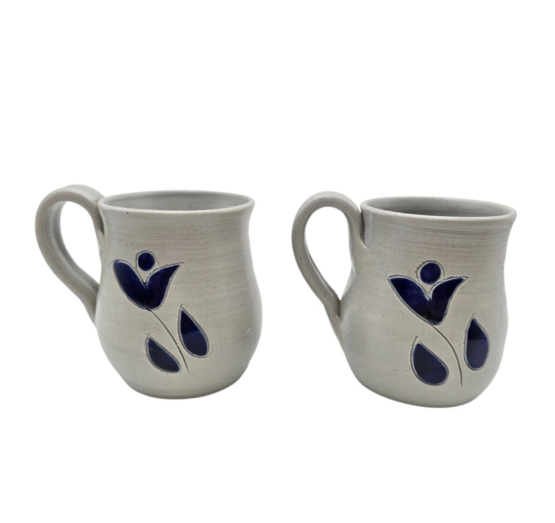 Set Of 2 Williamsburg Pottery Salt Glaze Round Coffee Mugs: A beautiful set of two matching artisan-crafted stoneware mugs. Each mug features a distinct hand-thrown shape with comfortable large handles, finished in a minimalist speckled light grey glaze. The f