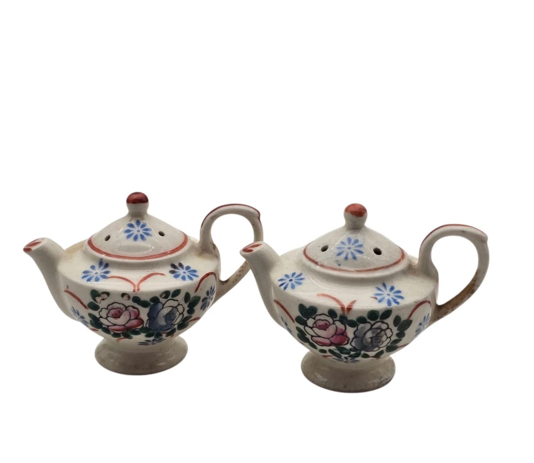 Floral Teapot Salt And Pepper Shakers Japan Hhite Blue: A dainty, matching miniature teapot shaker set. Each tiny teapot features a traditional pouring spout, loop handle, a removable-look molded lid knob, and classic hand-painted floral bouquets.Cream bas