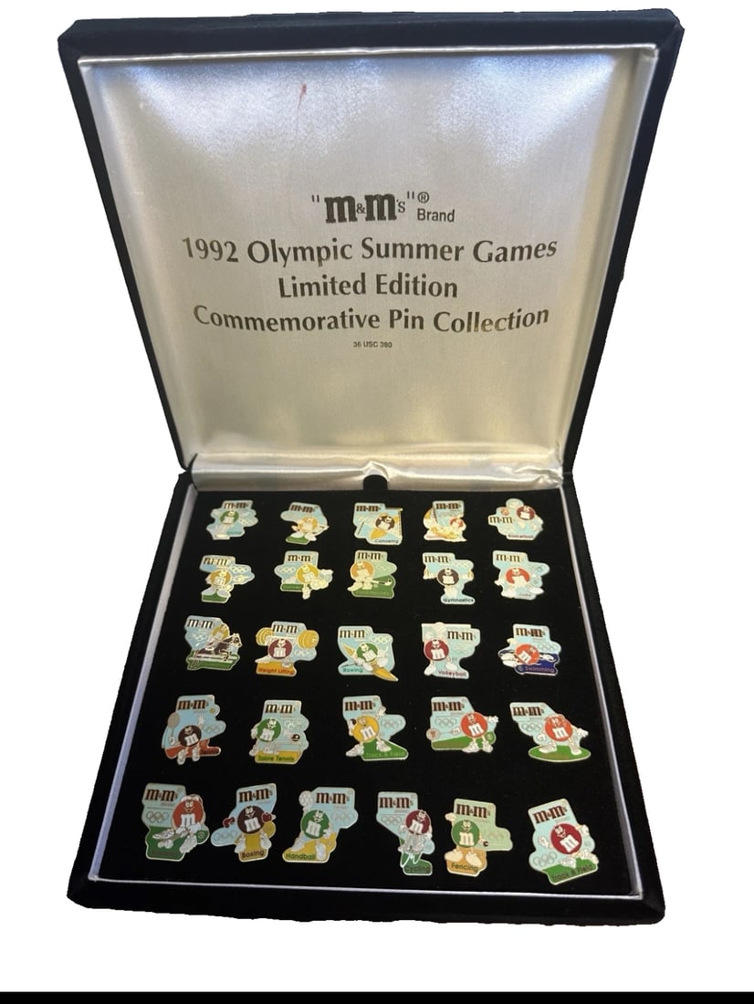 M & M's Brand 1992 Olympic Summer Games Limited Edition Pin Collection 26 Pc Box: A pristine, complete 1992 Olympic Summer Games Limited Edition Commemorative Pin Collection sponsored by M&M's Brand. Features 25 individual colorful enamel pins showcasing the iconic M&M's
