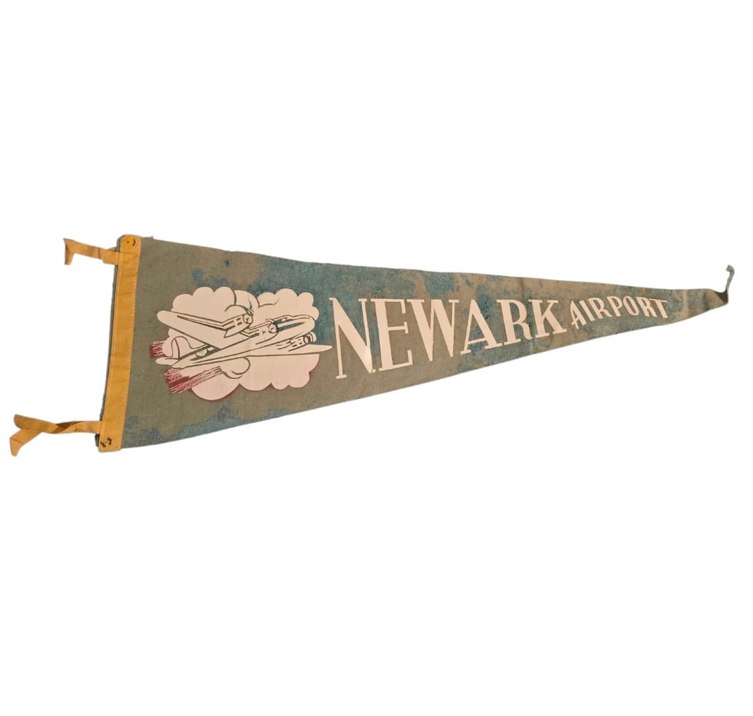 Vintage Newark Airport Pennant Plane - NJ: A rare, highly nostalgic vintage aviation travel pennant from Newark Airport (New Jersey). Crafted with a faded sage green/grey felt body, a golden-yellow spine, and matching ties.
