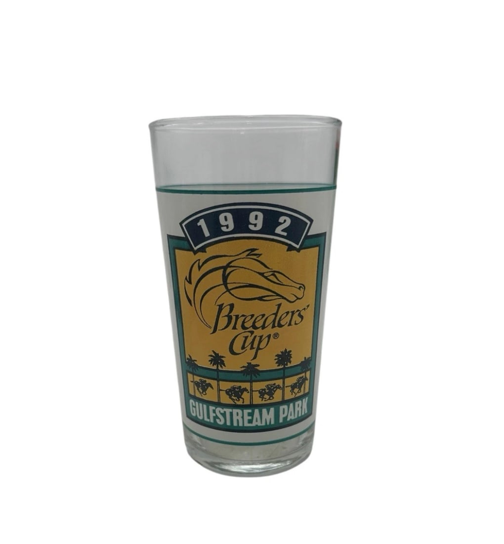 1992 Breeders' Cup Gulfstream Park Souvenir Glass: Celebrate Florida racing history with this official souvenir glass from the 1992 Breeders' Cup held at Gulfstream Park. Features a bright, retro-themed yellow and teal-bordered oval emblem highlightin