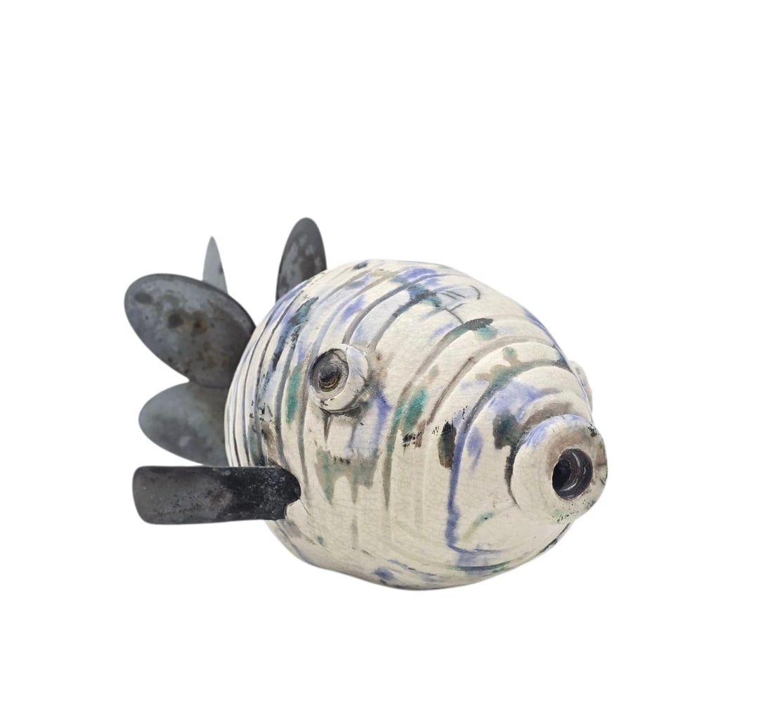 Unique Upcycled Metal Propeller Tail Ceramic Fish Art Sculpture Figurine: Unique, hand-crafted studio art pottery whimsical fish sculpture. The clay body is decorated with carved vertical ridges and a lovely crackle glaze featuring abstract streaks of periwinkle blue, seafo