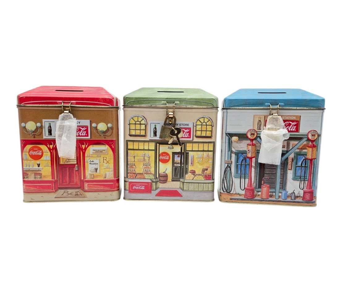 Set Of 3 Coca Cola Banks With Locks Shaped Like Houses 6" Tall: Vintage lot of three licensed Coca-Cola collectible tin coin savings banks designed as retro main street storefront buildings.