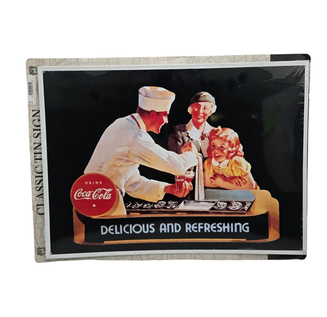 Vintage Coca Cola Coke Delicious And Refreshing Tin Sign Soda Jerk: classic 1950s soda fountain scene. The artwork features a soda jerk pouring a fresh glass of Coca-Cola for a mother and her young daughter.