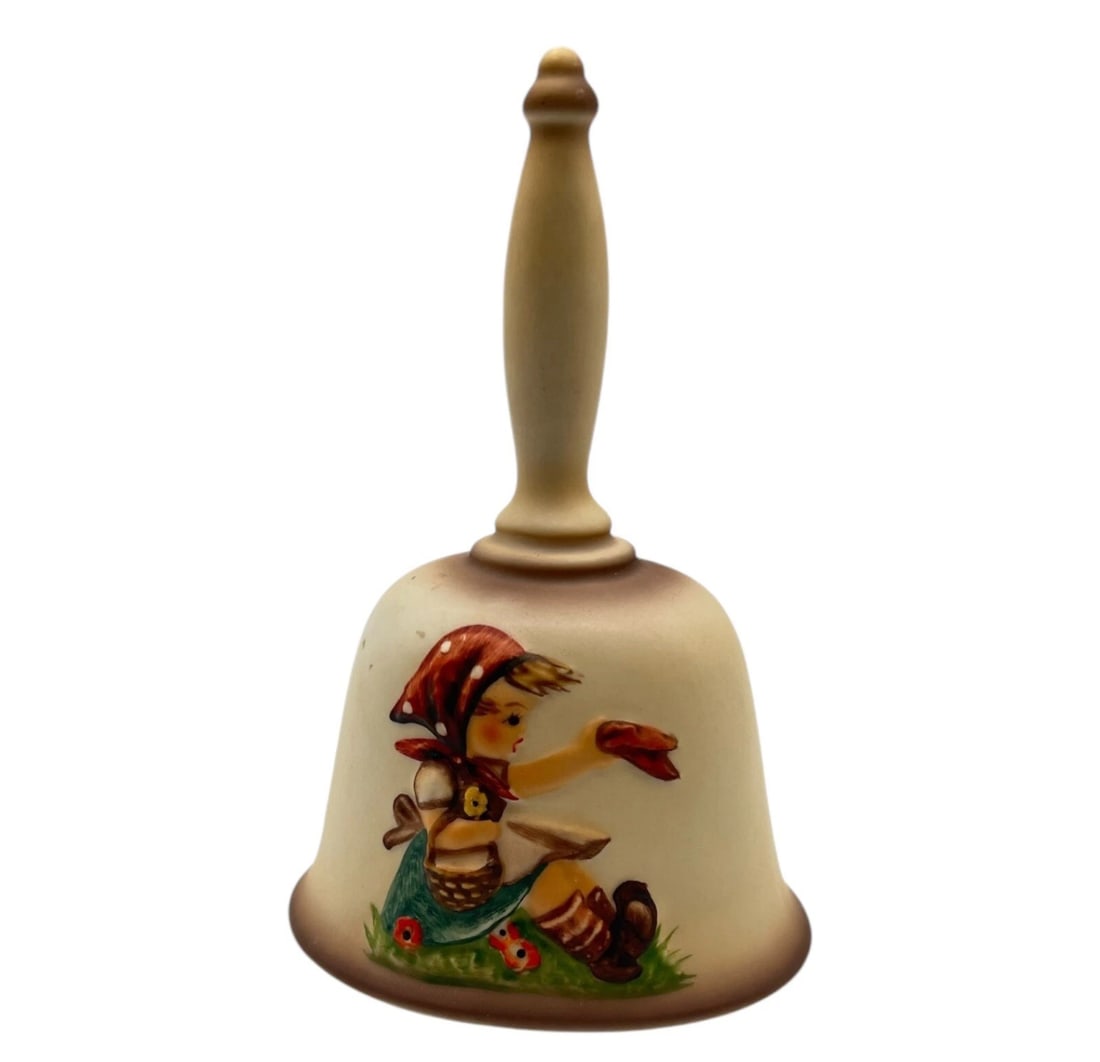 Vintage Goebel Hummel Figurine Second Edition Annual Bell 1979 HUM701: Hummel collector series. This matte-finished ceramic hand bell features a beautifully painted relief design of a young girl wearing a red headscarf, sitting in the grass with a woven basket on her arm