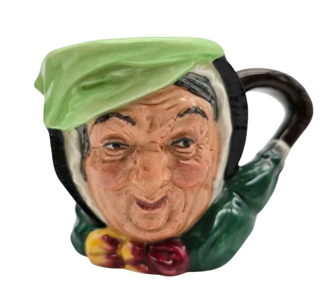 Royal Doulton Sairy Gamp Small Character Toby Mug Jug, A Mark, 3 1/8": A classic, highly collectible miniature porcelain Toby or character jug from the renowned English pottery company Royal Doulton. This jug depicts "Old Charley," a traditional 19th-century London night