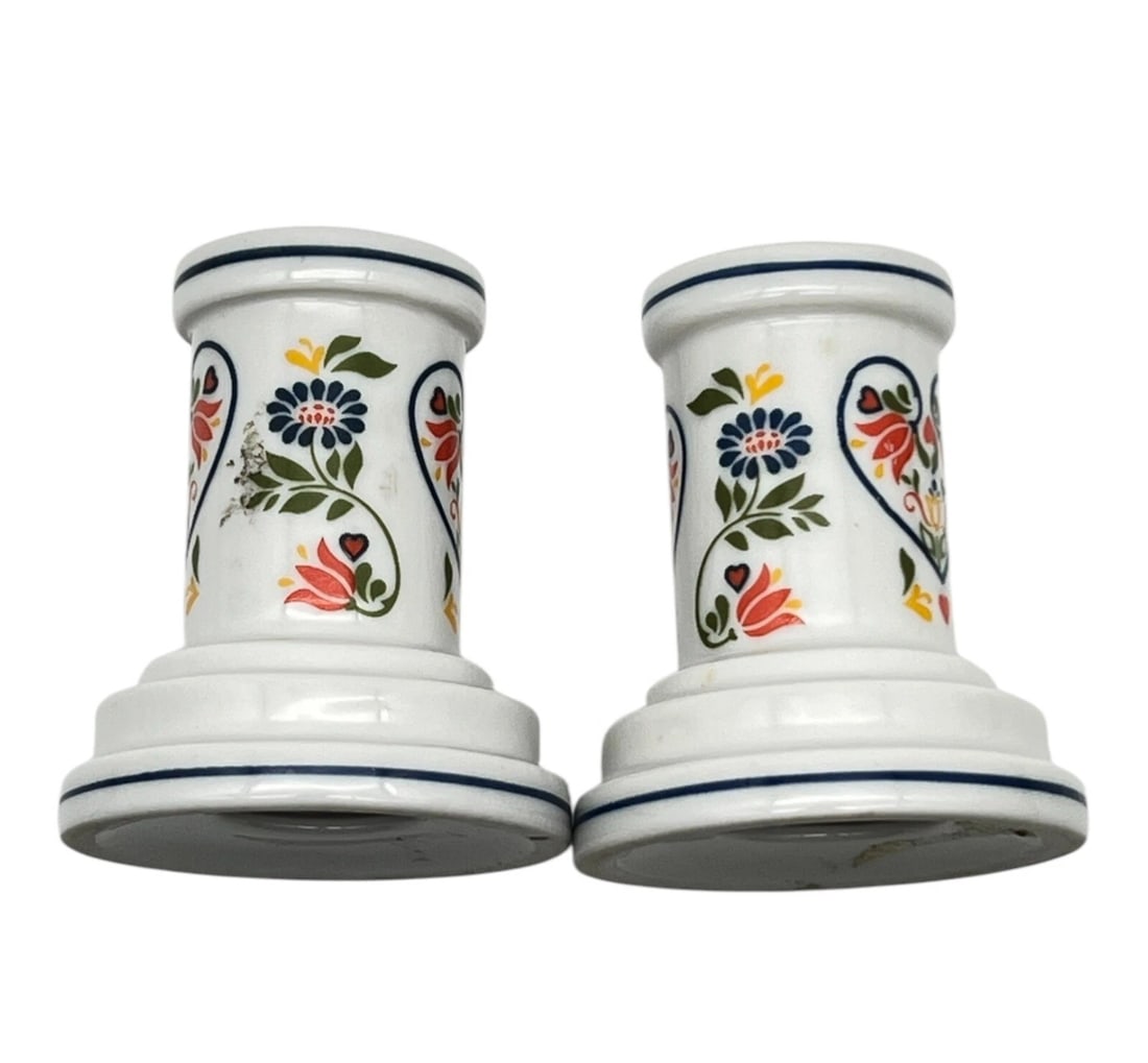 Vintage Candle Compliments Crowning Touch Floral Taper Candle Holders: A matching pair of small, white glazed porcelain or ceramic pillar candlestick holders. They feature a flared base and a simple cylindrical neck accented with thin painted blue rings along the top and