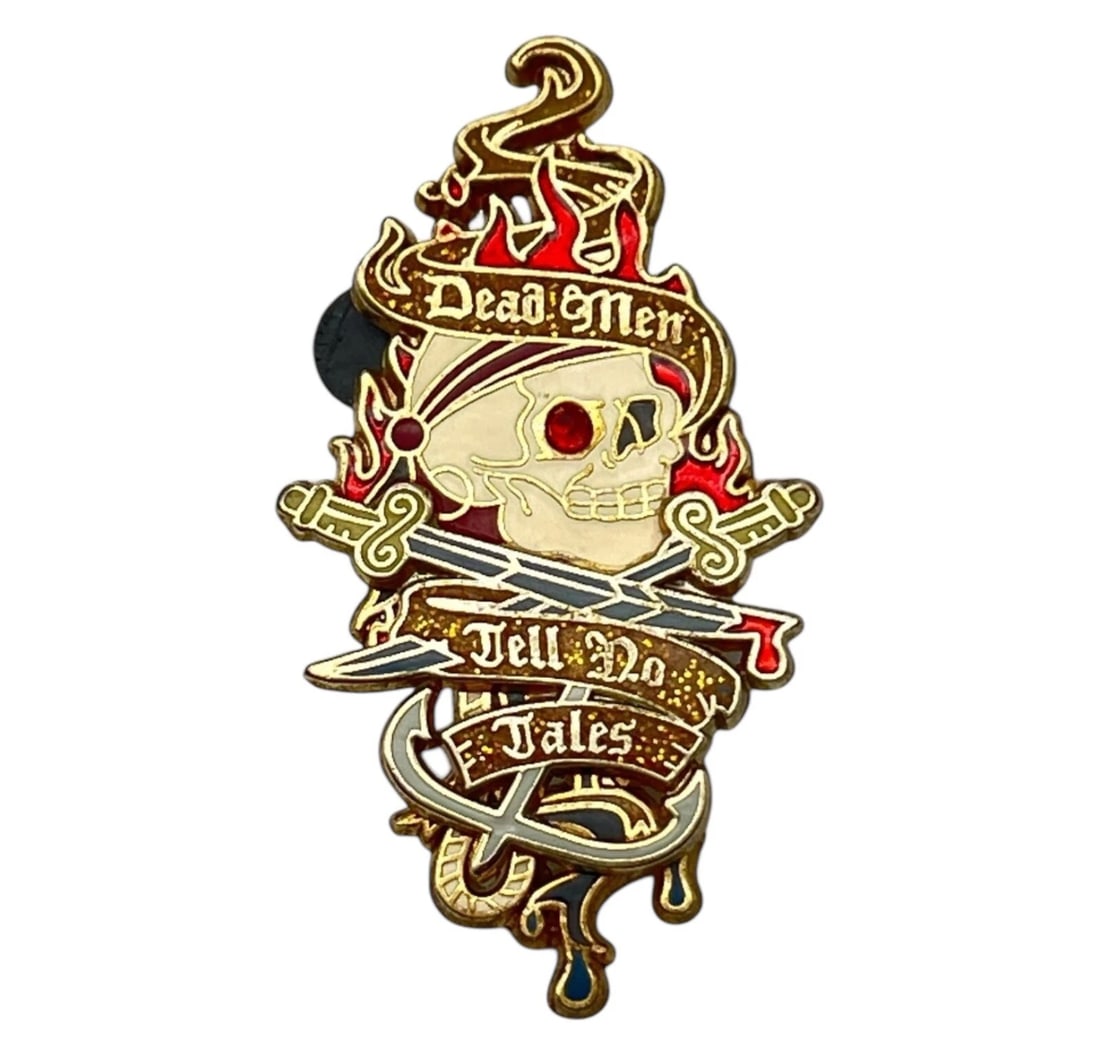 Pirates of the Caribbean Dead Men Tell No Tales Jeweled Skull Disney Pin 2006: A highly stylized, gothic-themed pirate enamel pin featuring a skull, red bandana, crossed cutlasses, and glittery banners. An edgy fashion accessory for jackets or bags, a great addition to a Hallowe