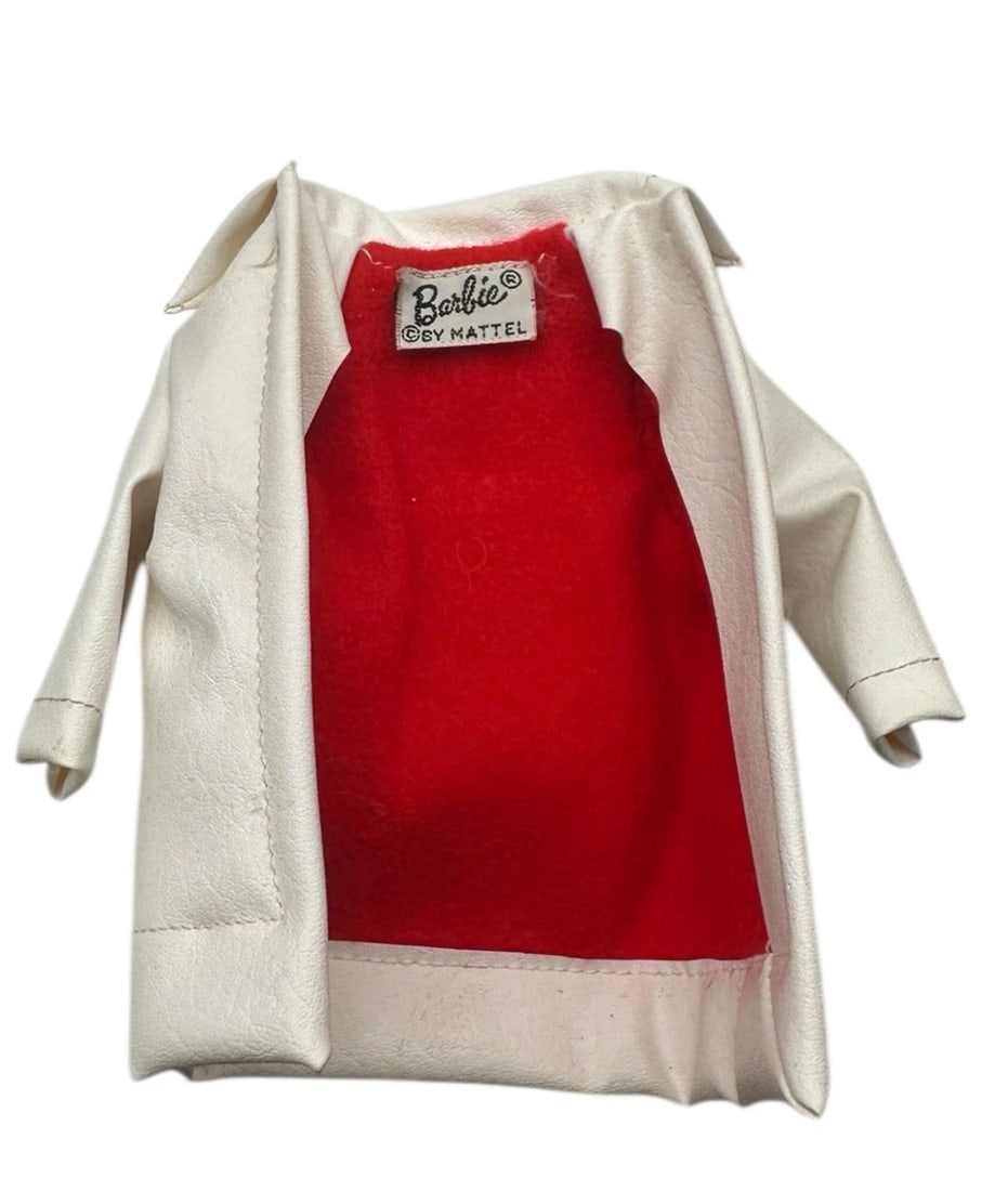 Barbie Winter Holiday Coat Mattel #975 White Vinyl Red Fleece 1959-63 Vintage #1: An authentic vintage Barbie winter coat made from textured white faux-leather (vinyl) with a contrasting bright red interior lining. It features a prominent wide collar and an original "Barbie® ©BY 