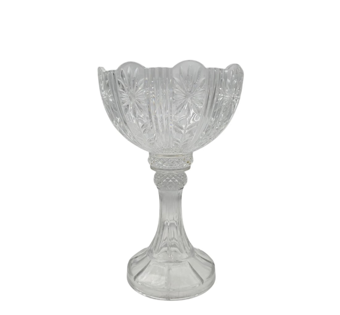 Design Guild Corinthian Pedestal Bowl Compote Crystal Fruit Counter Piece 14" T: An elegant, clear pressed or cut glass pedestal centerpiece bowl. The upper chalice-style basin features a scalloped rim and a repeating etched pinwheel or floral starburst design, supported by a thic