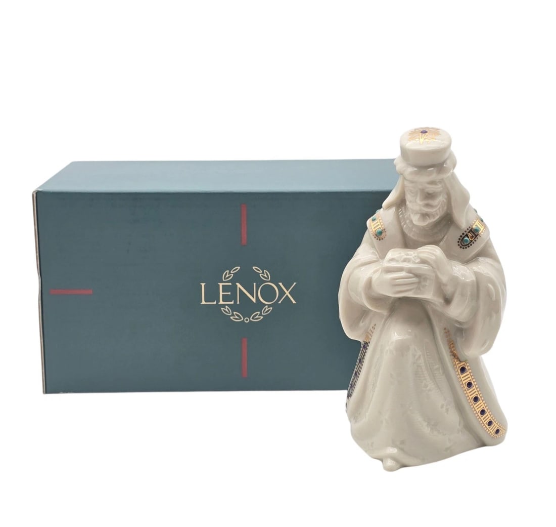 Lenox China Jewels Nativity Balthazaar In Box: A fine ivory porcelain nativity figurine from Lenox, depicting a kneeling Wise Man (Magi) presenting a gift. It is intricately detailed with multi-colored jeweled accents and fine gold trim, and comes
