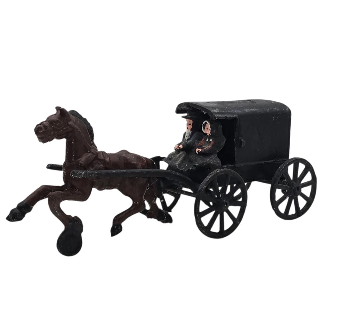 Vintage Cast Iron Metal Amish Family Horse Drawn Carriage Wagon Buggy: rustic miniature cast iron sculpture depicting a traditional Amish horse and buggy. The set features a dark brown horse in mid-stride pulling a classic black enclosed carriage. Inside, two hand-painte