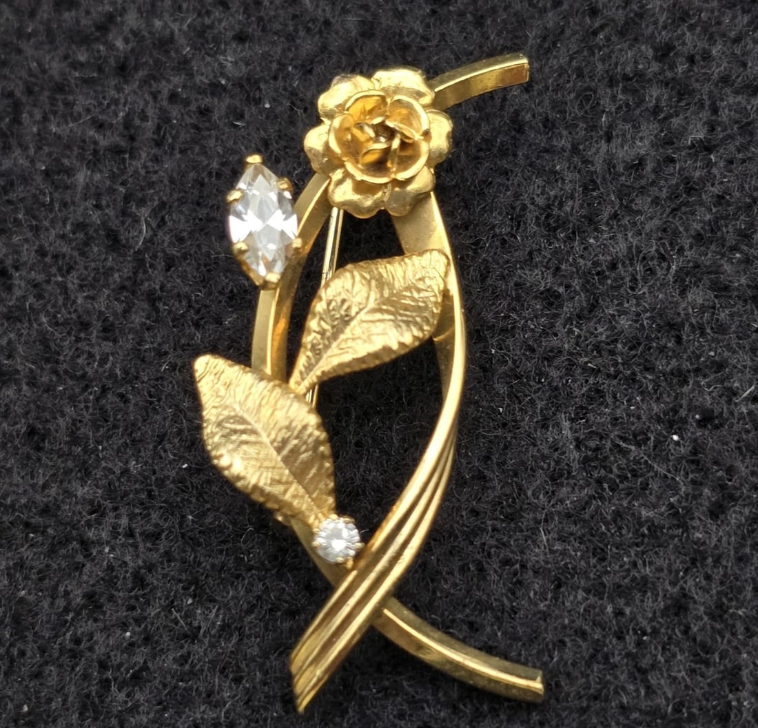 Elegant Vintage 14 GF Floral Brooch Pin with Two Marquise & Round Cut Rhines: gold-tone floral branch pin featuring a detailed 3D rose bloom and two finely textured leaves. The stem is elegant and sweeping, accented with one clear, brilliant marquise-cut rhinestone blossom and