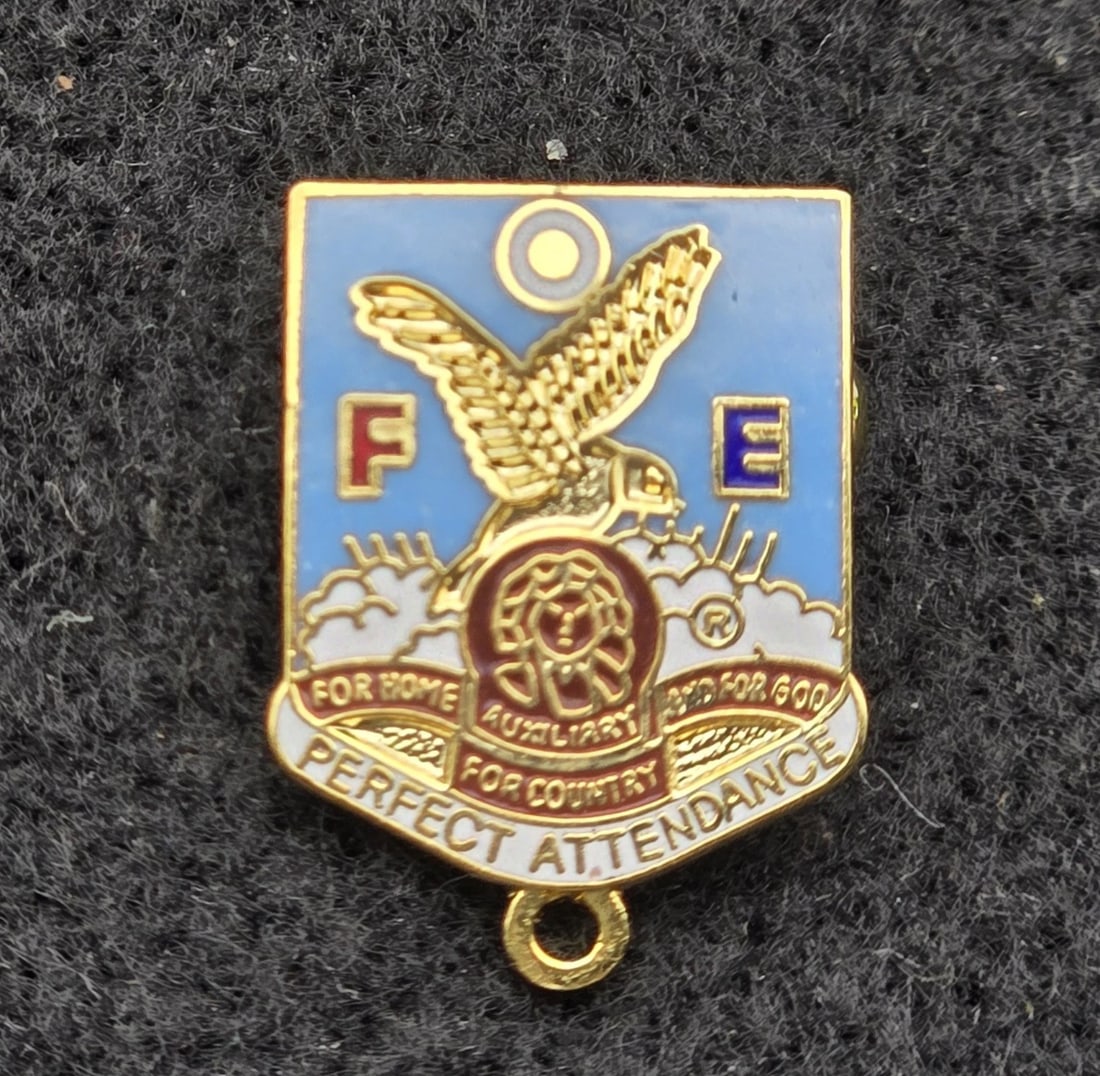 FOE Ladies Auxiliary Enamel Lapel Pin Perfect Attendance: An authentic vintage enameled membership pin for the Fraternal Order of Eagles (F.O.E.) Ladies Auxiliary. The shield-shaped design features a soaring golden eagle, the letters "F" and "E," the auxilia