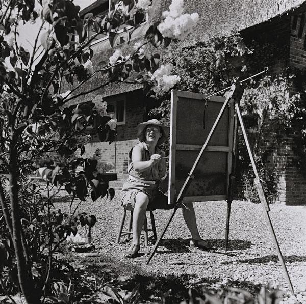 BESNYÖ, Eva (1910-2003).: BESNYÖ, Eva (1910-2003). Charley Toorop paints the blossoms in her garden, Bergen, North Holland. Silver print, with the photographer's copyright stamp on the reverse 'Eva Besnyö Fotografe gkf Vonde