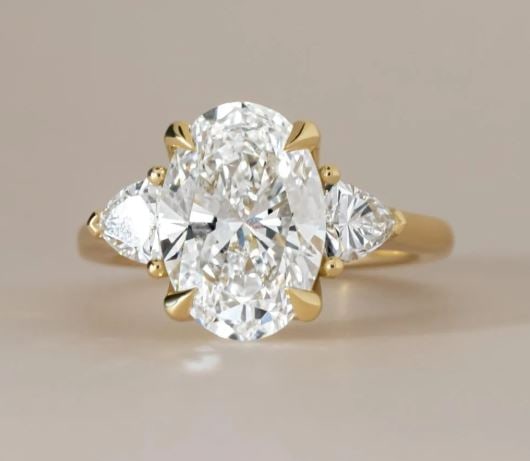 5 Carat Lab Grown Oval Diamond Trilogy Engagement Ring in 14kt Yellow Gold: 5 Carat Lab Grown Oval Diamond Trilogy Engagement Ring in 14kt Yellow Gold Ring Us 7.00 us Ring Size change available