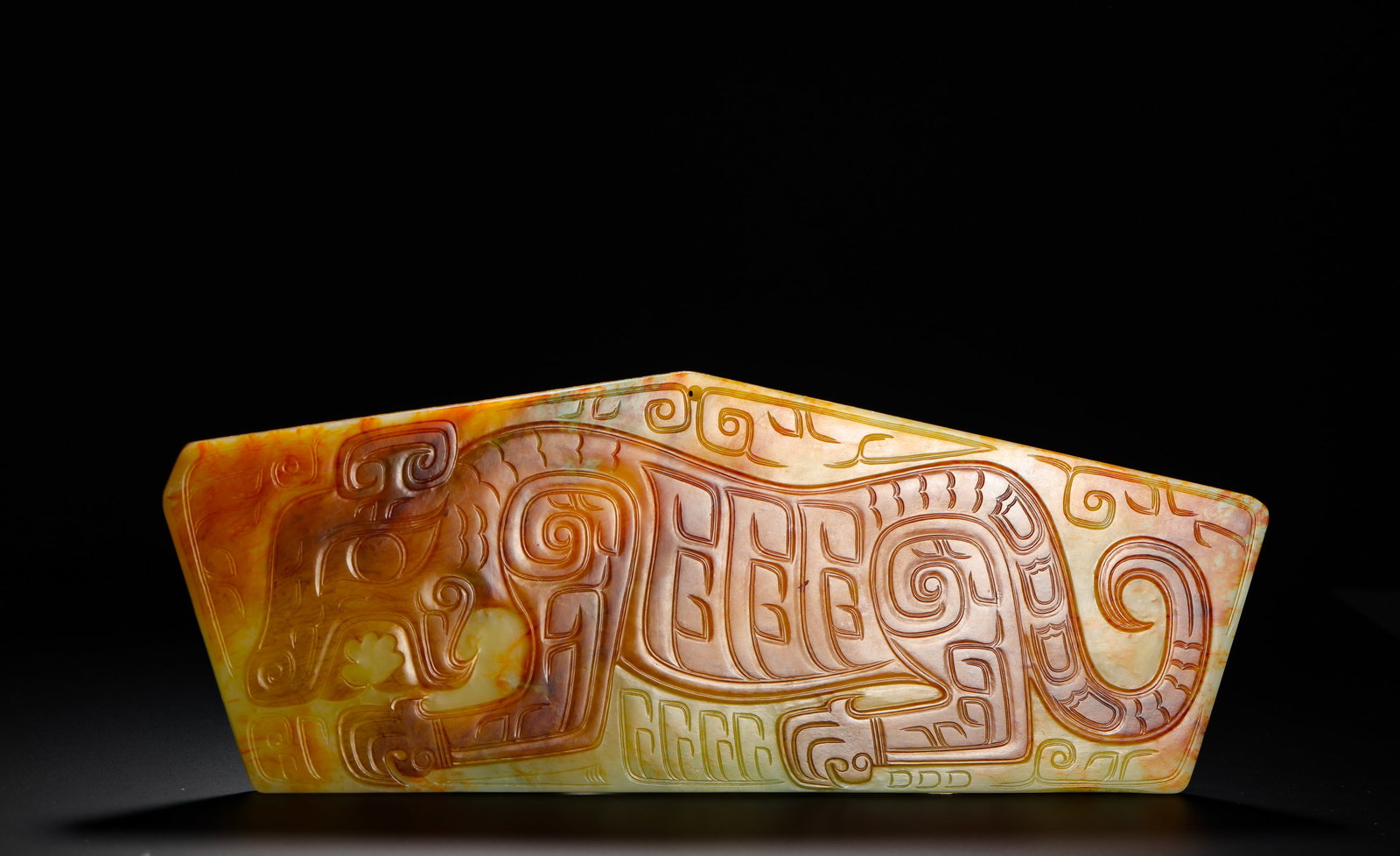 HETIAN JADE TIGER-PATTERNED ORNAMENT FROM THE WESTERN ZHOU DYNASTY: H:13cm (5.12in) W:35.5cm (13.98in) Weight:960g (2.12lb)This is a Western Zhou Dynasty Hetian jade pendant, carved from smooth bluish-yellow jade with large natural red patina, exuding an ancient charm