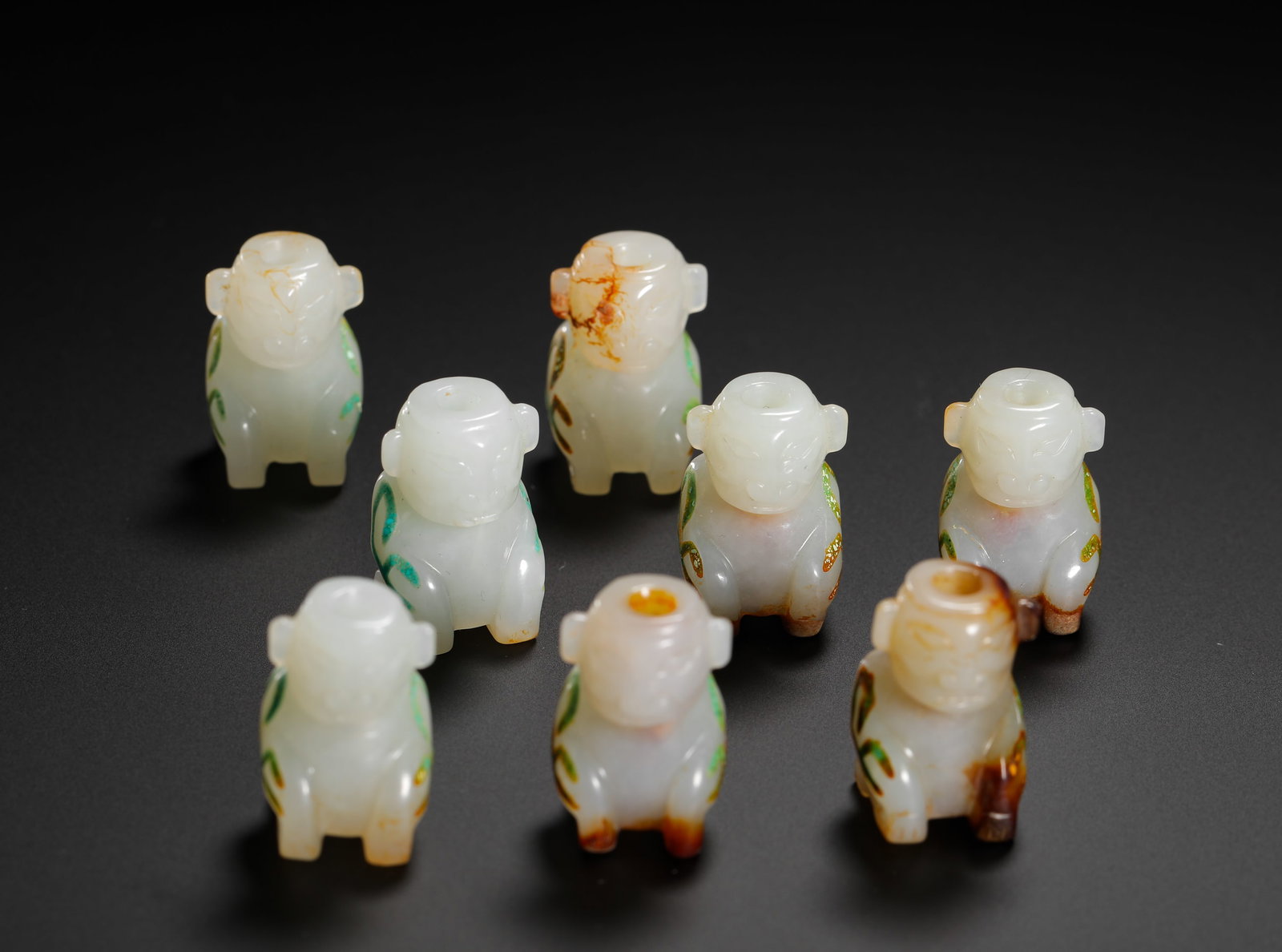 A SET OF HAN DYNASTY HETIAN JADE PENDANTS INLAID WITH TURQUOISE: H:2.5cm (0.98in) W:1.5cm (0.59in) Weight:50g (0.11lb)This is a set of eight Han Dynasty Hetian jade deity pendants, carved from smooth white jade with natural reddish-brown patina. The deities are dep