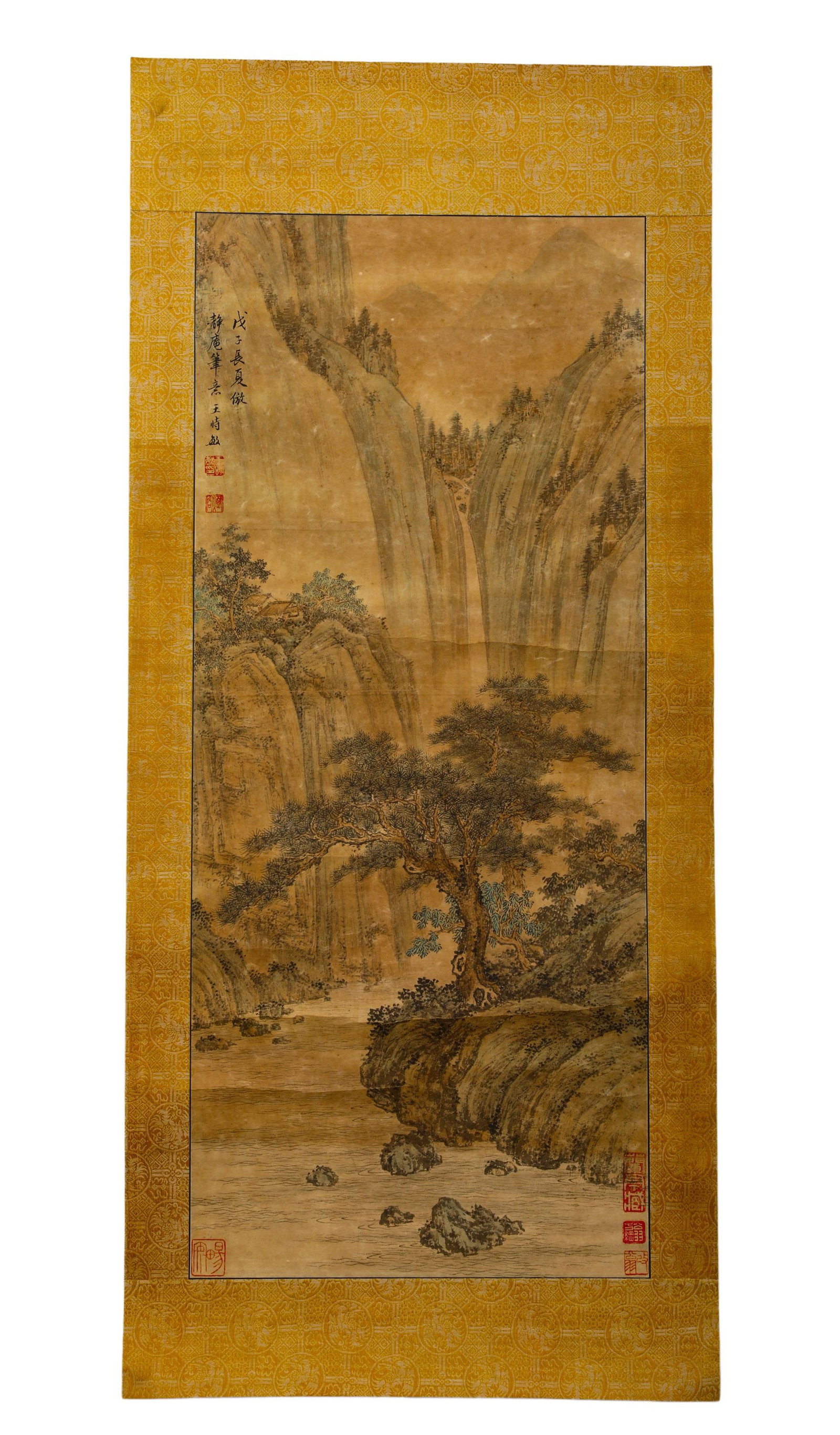 WANG SHIMIN OF THE QING DYNASTY (1592-1686) ANCIENT PAPER LANDSCAPE SCROLL OF STREAMS, MOUNTAINS AND: H:78cm (30.71in) W:33cm (12.99in)Light ochre literati landscape scroll mounted with imperial yellow patterned silk brocade, the paper has aged to a warm vintage tea tone with natural patina.The painti