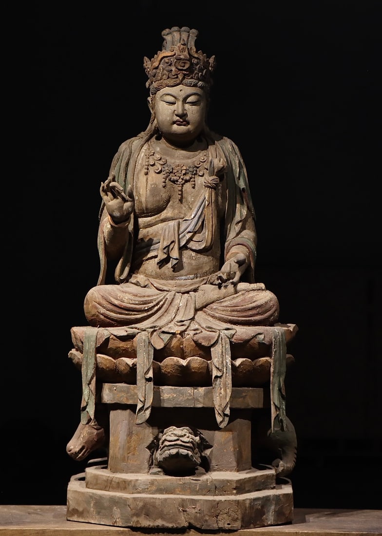 SONG DYNASTY NANMU GUANYIN STATUE: H:130cm(51.18in) W:60cm(23.62in) T:55cm(21.65in)This is a Song Dynasty wooden painted seated statue of Guanyin Bodhisattva. Carved from solid wood, it is decorated with lacquer and mineral pigments. T