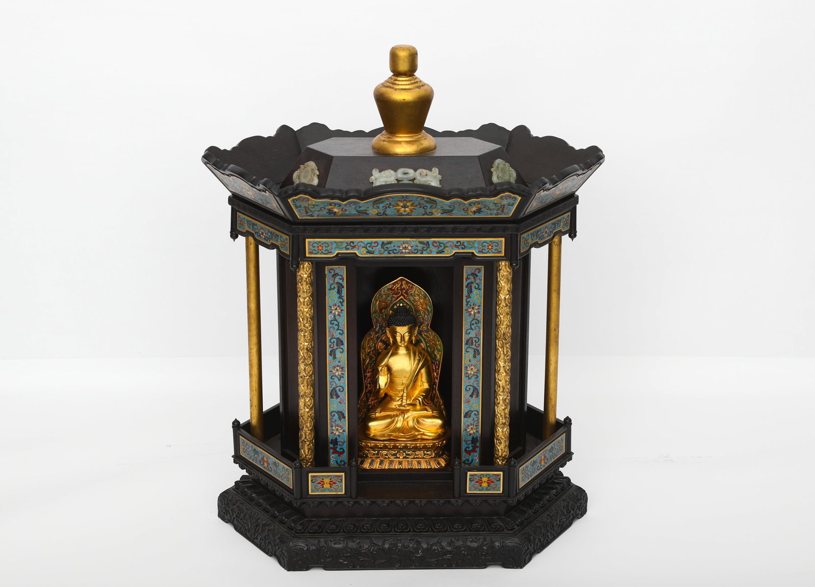 A HEXAGONAL BUDDHA NICHE INLAID WITH ENAMEL AND GILDING IN ROSEWOOD OF THE QING DYNASTY: H:60cm (23.62in) W:50cm (19.69in) Weight:15000g (33.07lb)This is a hexagonal Buddhist niche in the Qing Dynasty palace style, crafted from finely carved zitan wood, with a base decorated with scrollin