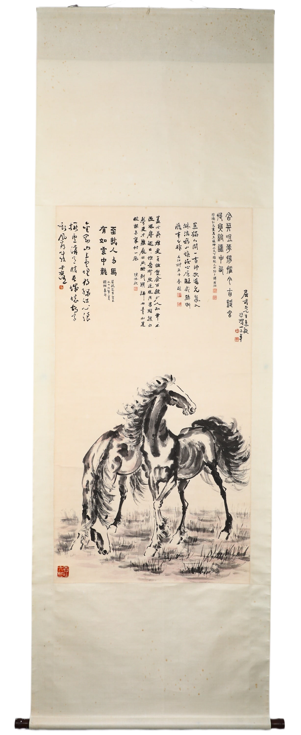 XU BEIHONG (1895-1953) INK-WASH PAINTING OF TWO HORSES ON A VERTICAL SCROLL: H:130cm (51.18in) W:69cm (27.17in)Vertical ink scroll on paper, depicting two thoroughbred horses in wilderness. One horse looks back with head raised, the other grazes with head lowered. Bold freehan