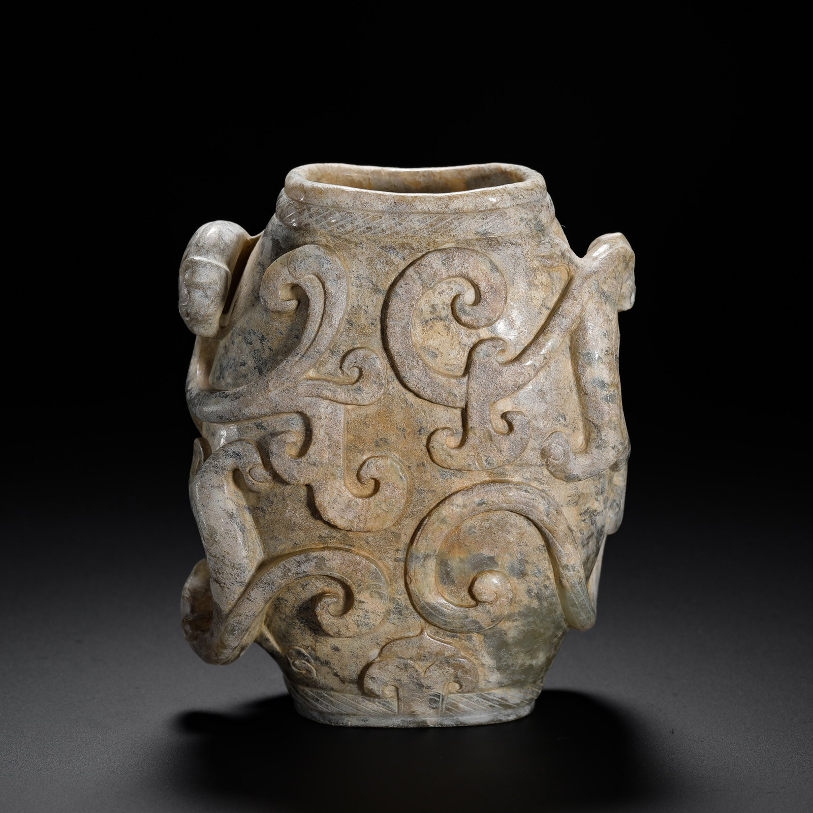 HAN DYNASTY HETIAN JADE CHILONG-PATTERNED CUPS: H:10cmW:8.5cmWeight:360g A Han Dynasty jade jar fully carved with chi dragons, covered in natural patina, an important ancient jade ornament.