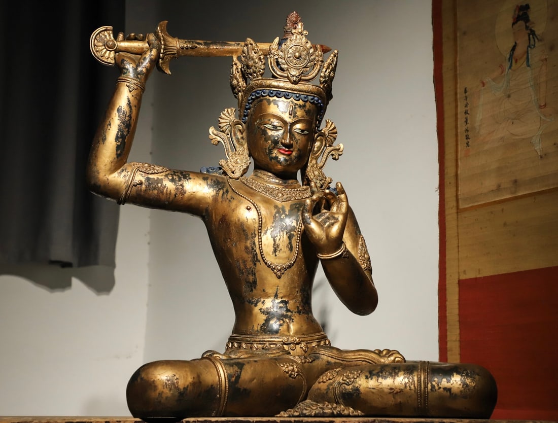 A GILDED BRONZE STATUE OF MANJUSRI BODHISATTVA HOLDING A SWORD FROM THE QING DYNASTY: Weight:23000g.H:72cmL:56cmW:35cm