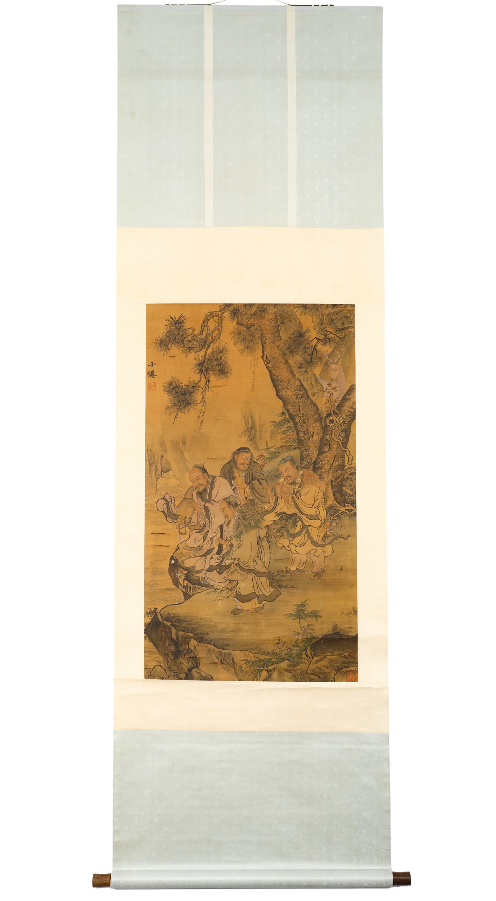 MING XIAOXIAN (WU WEI, 1459-1508) ANCIENT SILK SCROLL OF THE GROUP OF IMMORTALS IN SONGXI: H:95cm (37.40in) W:53cm (20.87in)Color Taoist figure scroll on aged warm yellow silk mounted with three-tone silk brocade. It depicts twisted ancient pine, bamboo and rocks by a stream, with four immo