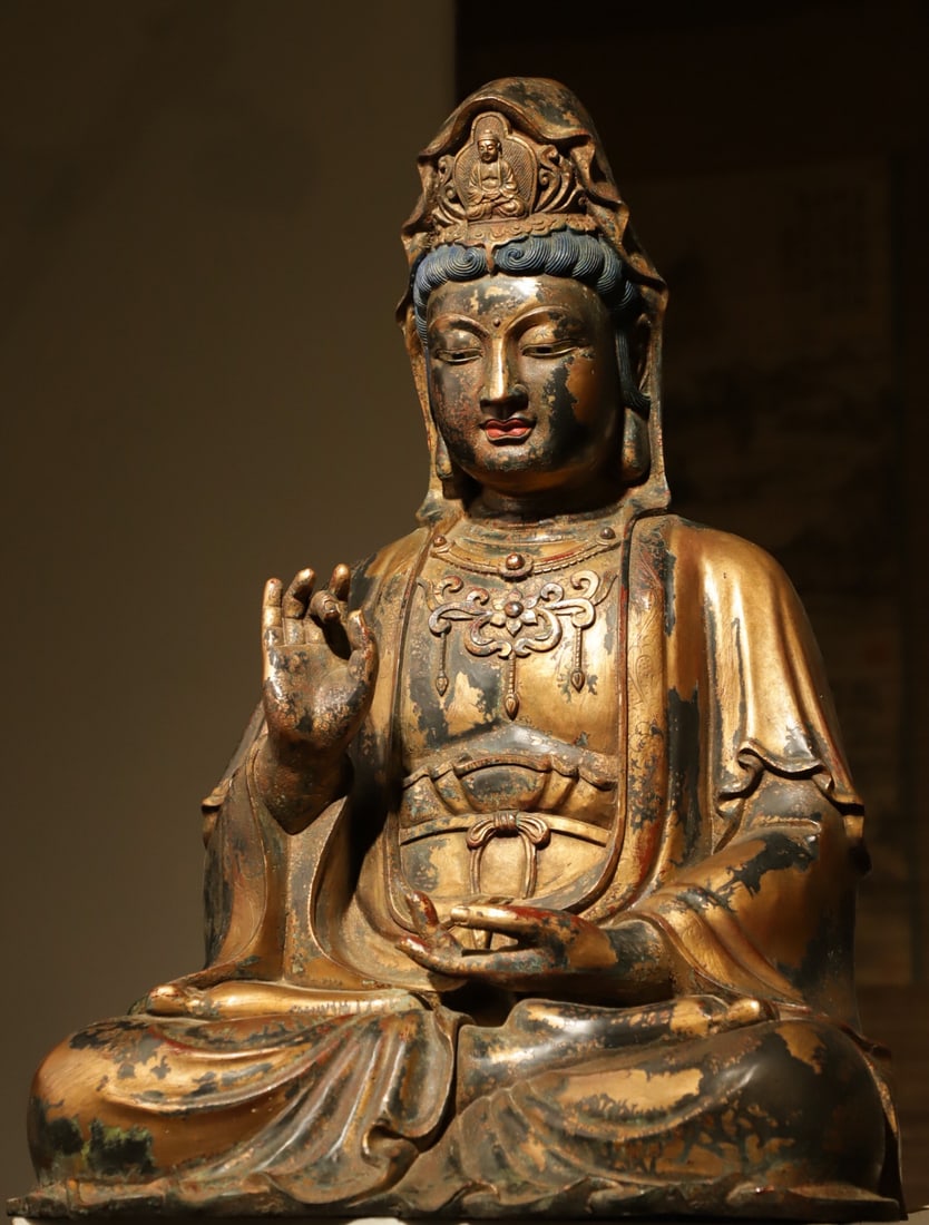GILDED BRONZE STATUE OF GUANYIN BODHISATTVA FROM THE MING DYNASTY: Weight:20000g(44.09lb) H:66cm(25.98in) L:45cm(17.72in) W:36cm(14.17in) This is a Ming Dynasty gilt-bronze seated statue of Guanyin Bodhisattva. Cast from fine bronze with overall gilding and mineral p