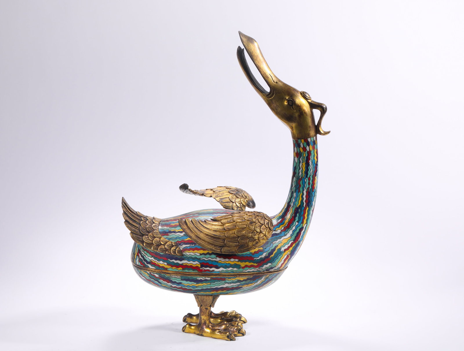 QING DYNASTY COPPER BODY CLOISONNE ENAMEL GILDED GOOSE SHAPE LID BOX: H:45.0cm(17.72in) W:30.0cm(11.81in) Weight:5570g(12.28lb)This covered box is a masterpiece of the craftsmanship of the Qing Dynasty Imperial Workshop. Made of fine bronze with full-body cloisonné ena