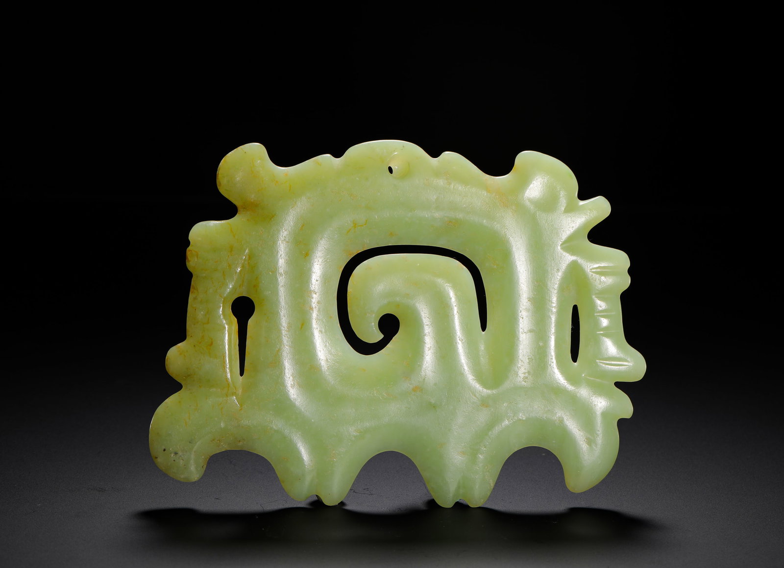 RED MOUNTAIN CULTURE YELLOW JADE HOOK-SHAPED PENDANT: H:11cmW:15.3cmWeight:210g Iconic Hongshan cloud hook pendant carved from yellowish green jade, hollowed-out swirling cloud patterns with jagged flanges, perforated at top for threading, a vital ancien